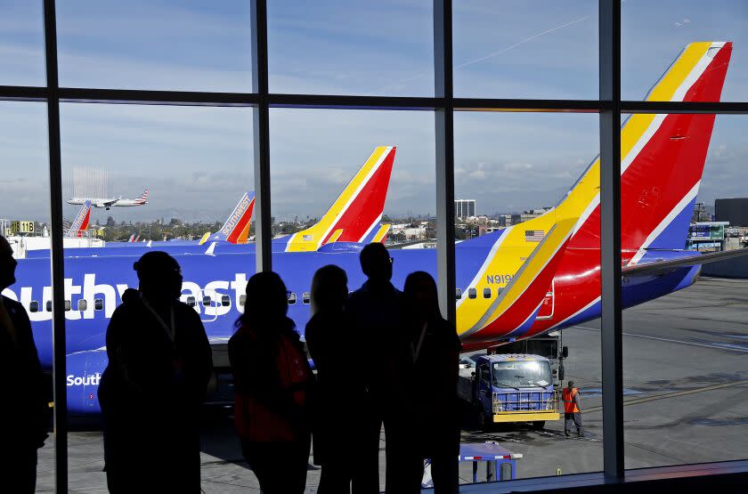 LOS ANGELES, CA - NOVEMBER 30, 2018. Southwest Airlines staff with Southwest planes as a backdrop during a ceremony unveiling the new Terminal 1 at Los Angeles International Airport (LAX) November 30, 2018. Southwest is the exclusive carrier of Terminal 1 at LAX. Southwest and Los Angeles World Airports (LAWA) partnered with Unibail-Rodamco-Westfield (URW Airports) to spend $516.7 million on an expanded dining and retail program showcasing local LA brands. (Al Seib / Los Angeles Times)