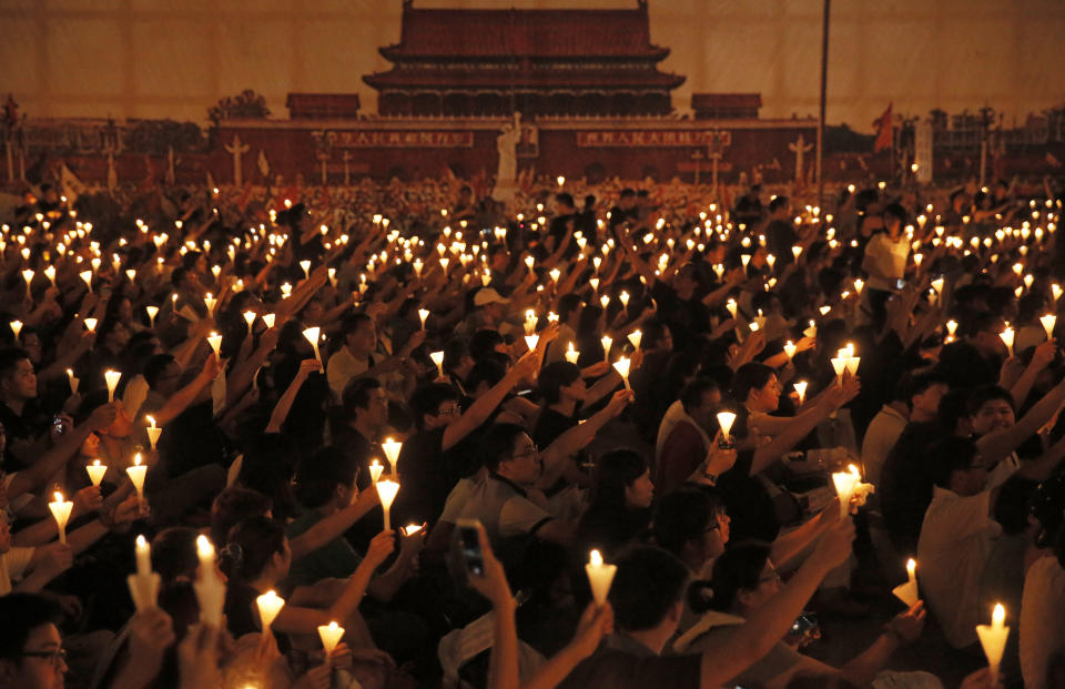 FILE - People attend a candlelight vigil at Victoria Park in Hong Kong on June 4, 2015, marking the 1989 student-led Tiananmen Square protests. (AP Photo/Vincent Yu, File)