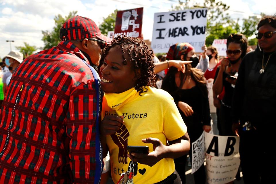 Eastpointe Mayor Monique Owens and the Rev. WJ Rideout III join protesters in a march down Hall Road in Sterling Heights as part of an anti-police brutality rally on Saturday, May 6, 2020.