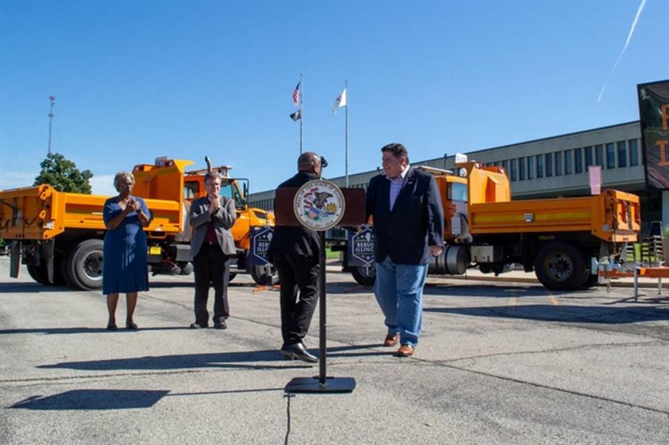 Gov. J.B. Pritzker shakes the hand of Illinois Department of Transportation Secretary Omer Osman outside the IDOT building in Springfield on Friday. The pair and other local officials outlined the state’s six-year infrastructure spending plan.