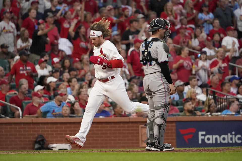 St. Louis Cardinals' Brendan Donovan, left, scores past Miami Marlins catcher Nick Fortes (54) during the fifth inning of a baseball game Tuesday, June 28, 2022, in St. Louis. (AP Photo/Jeff Roberson)