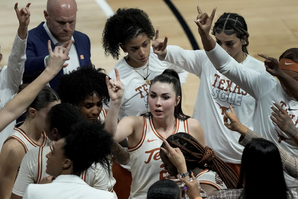 Texas guard Shaylee Gonzales, center, huddles with teammates during an NCAA college basketball game against Kansas State in the the Big 12 Conference tournament Friday, March 10, 2023, in Kansas City, Mo. (AP Photo/Charlie Riedel)