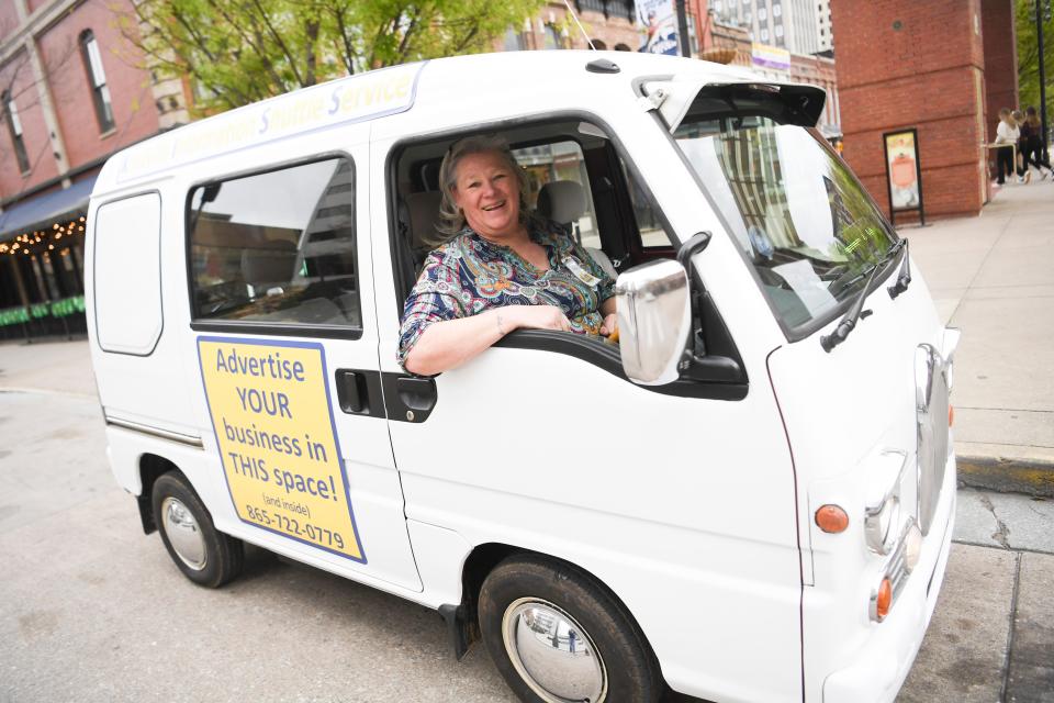 Owner Gina Kelly poses behind the wheel of one of her KISS Caboose vehicles, which have been offering free rides to Knoxville residents and visitors since 2021. The shuttle component of the business has ended, however, due to "insurance concerns," but the vehicles could still be spotted around town serving as mobile billboards for local businesses.