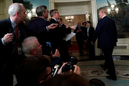 Reporters ask questions as U.S. President Donald Trump departs after signing a memorandum on intellectual property tariffs on high-tech goods from China, at the White House in Washington, U.S. March 22, 2018. REUTERS/Jonathan Ernst