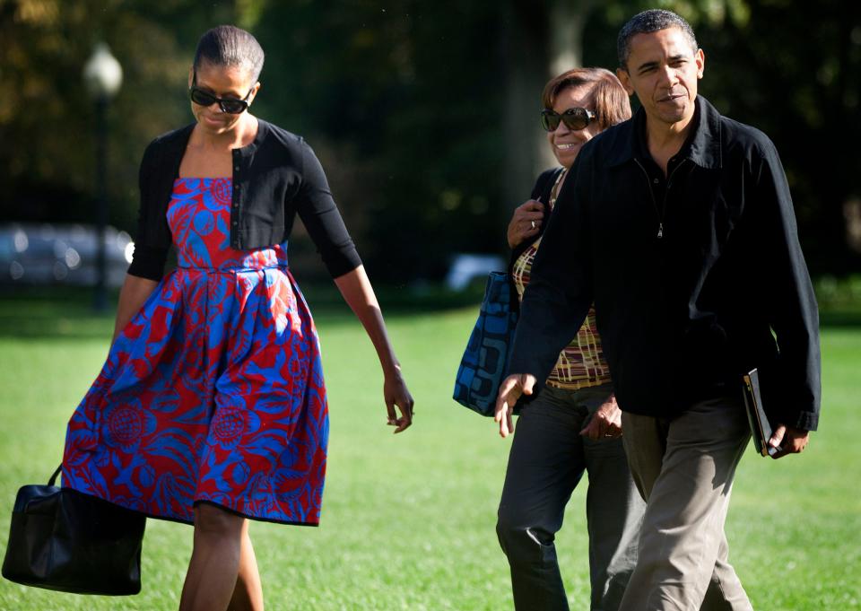 Michelle Obama wears a red and blue dress while returning from Camp David with Barack Obama and her mother.