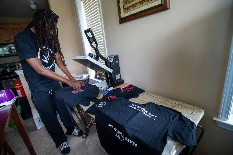 Darryl Harvin, owner of Crooked Crown Apparel, a two-year-old Asbury Park-based provider of modern streetwear, heat presses a logo onto a T-shirt at his brother's home in Eatontown, NJ Thursday, July 7, 2022.