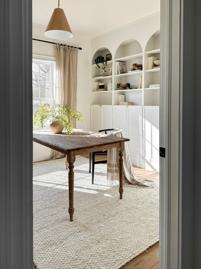 White custom Ikea Billy bookcase in dining room.