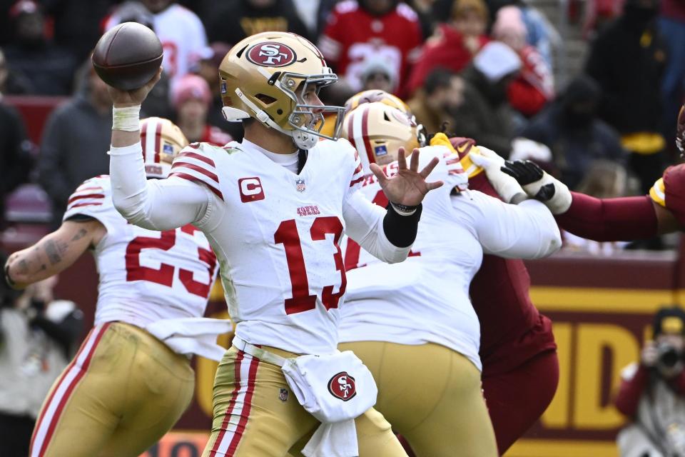 Dec 31, 2023; Landover, Maryland, USA; San Francisco 49ers quarterback Brock Purdy (13) attempts a pass against the Washington Commanders during the second half at FedExField. Mandatory Credit: Brad Mills-USA TODAY Sports