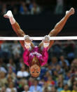 <p>Gabrielle Douglas performs on the asymmetric bars during the women’s individual all-around gymnastics final. (Mike Blake/Reuters) </p>