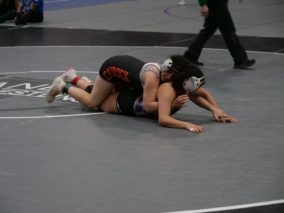 Caprock's Kareli Cadena (top) wrestles El Paso Bel Air's Alexandra Gaytan during the Region I Wrestling Tournament on Saturday, February 11, 2023 at the First United Bank Center in Canyon.