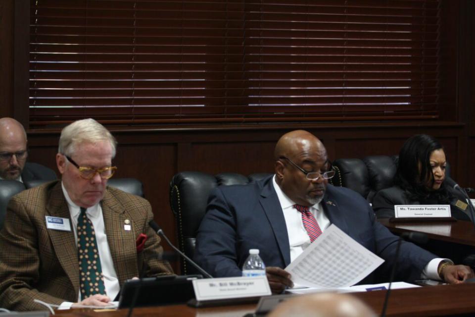 Board Member Bill McBrayer (left) and Lt. Gov Mark Robinson review Propel NC documents at the January State Board of Community Colleges meeting. Hannah Vinueza McClellan/EducationNC