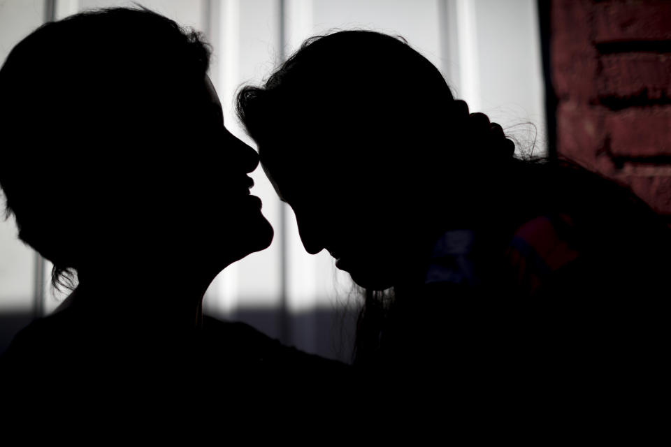 In this Aug. 1, 2019 photo, Paola Gonzalez, left, poses for a picture with her daughter, one of about 20 ex-students from the Antonio Próvalo School for Deaf and Hearing Impaired Children who say they were sexually abused by two Roman Catholic priests, including cases of rape, in Mendoza, Argentina. "Two and a half years have passed (since the Mendoza case was uncovered) and Francis has not uttered a single word to the survivors of the Próvolo in Mendoza," said González, referring to the Argentine pope. The priests go on trial Monday, Aug. 5. (AP Photo/Natacha Pisarenko)