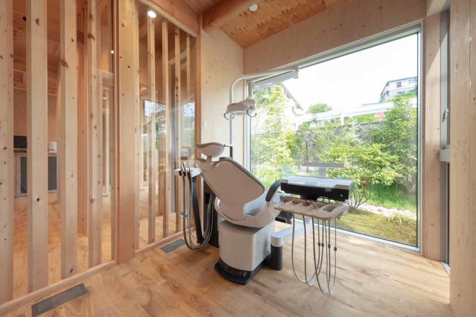 View outside from a wooden treatment room in YYA's Dentistry in the Forest clinic.