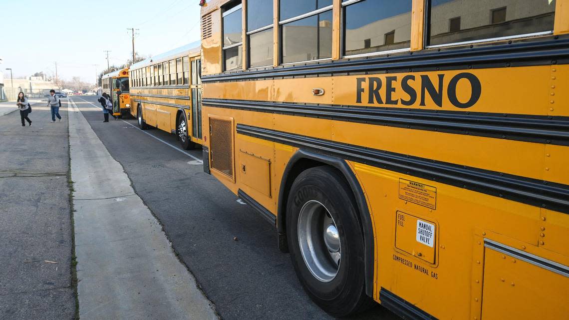 Fresno Unified School District buses arrive outside Edison High School and Computech Middle School to let students off before classes on Friday, Feb. 10, 2023.