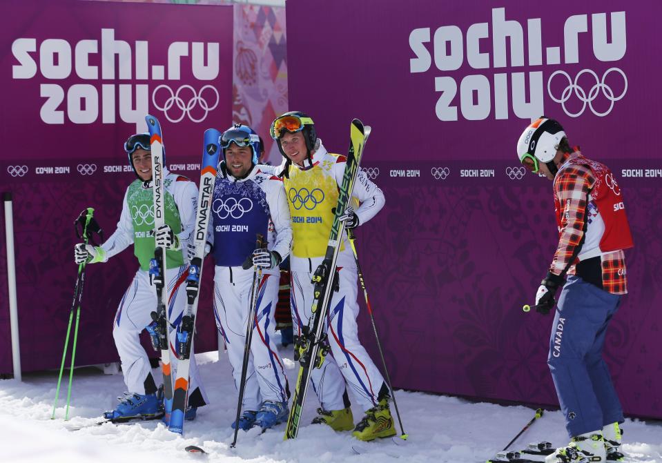 Fourth-placed Canada's Brady Leman (R) reacts as winner France's Jean Frederic Chapuis (L) poses with compatriots second-placed Arnaud Bovolenta (2nd L) and third-placed Jonathan Midol after their men's freestyle skiing skicross finals round at the 2014 Sochi Winter Olympic Games in Rosa Khutor February 20, 2014. REUTERS/Mike Blake (RUSSIA - Tags: SPORT OLYMPICS SPORT SKIING)