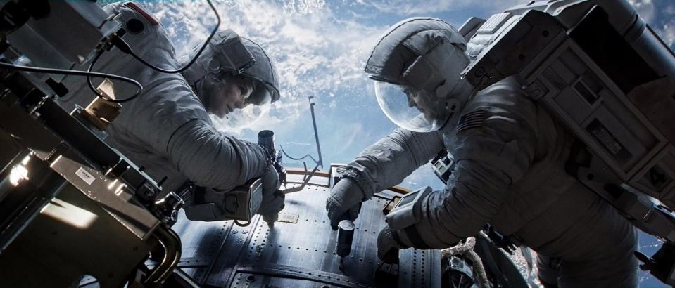 This publicity photo released by Warner Bros. Pictures shows Sandra Bullock, left, as Dr. Ryan Stone and George Clooney as Matt Kowalsky in “Gravity." (AP Photo/Courtesy Warner Bros. Pictures)