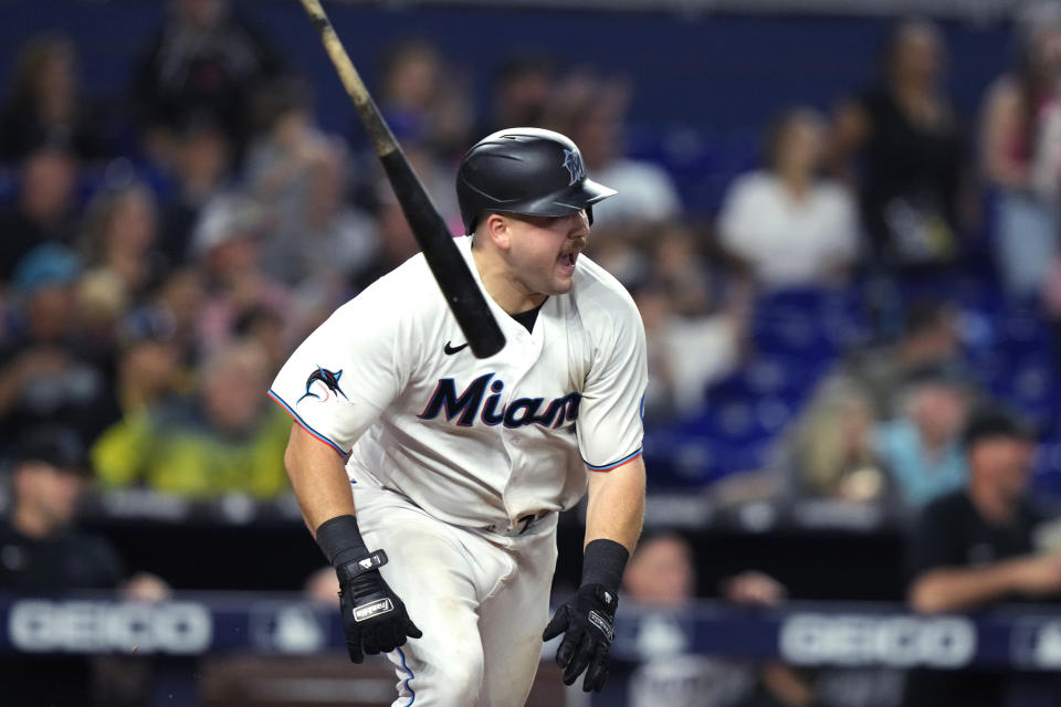 Miami Marlins' Jake Burger tosses his bat after hitting a single to drive in Joey Wendle with the winning run during the ninth inning of the tema's baseball game against the New York Mets, Tuesday, Sept. 19, 2023, in Miami. (AP Photo/Lynne Sladky)