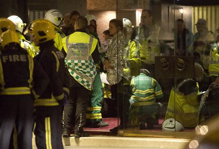 People receive medical attention after part of the ceiling at the Apollo Theatre on Shaftesbury Avenue collapsed in central London December 19, 2013. REUTERS/Neil Hall