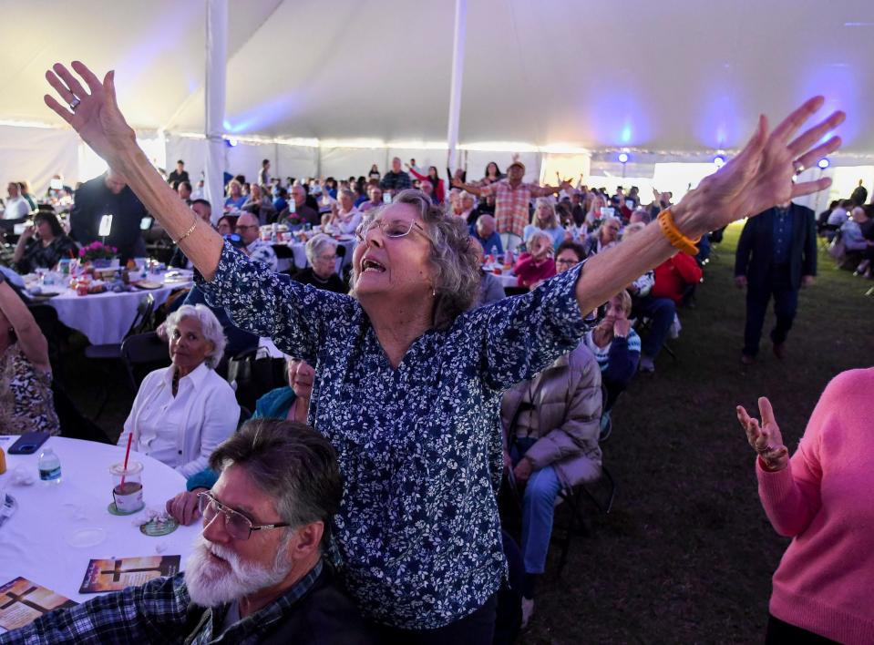 Vicki Snell, of Sebastian, sings along with Grammy and Dove award-winning artist Guy Penrod during the Vero Beach Prayer Breakfast, Thursday, Feb. 15, 2024, at Riverside Park. Thousands of people were in attendance under a tent the length of a football field, along with keynote speaker Jim Kelly, for the 20th annual breakfast.