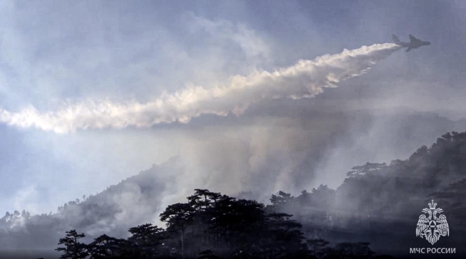 In this photo taken from video released on Sunday, July 18, 2021 by Russian Emergency Situations Ministry press service, a Russian Emergency Ministry's Beriev multipurpose amphibious aircraft Be-200 drops water during extinguishing a forest fire in the republic of Sakha also knows as Yakutia, Russia Far East. Russia has been plagued by widespread forest fires, blamed on unusually high temperatures and the neglect of fire safety rules, with Sakha-Yakutia in northeastern Siberia being the worst affected region lately. Each year, thousands of wildfires engulf wide swathes of Russia, destroying forests and shrouding broad territories in acrid smoke. This summer has seen particularly massive fires in Yakutia in northeastern Siberia following unprecedented heat. (Russian Emergency Situations Ministry press service via AP, File)