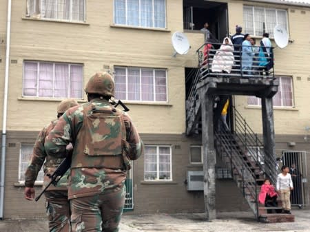 Soldiers patrol as they are deployed to quell gang violence in Manenberg township, Cape Town