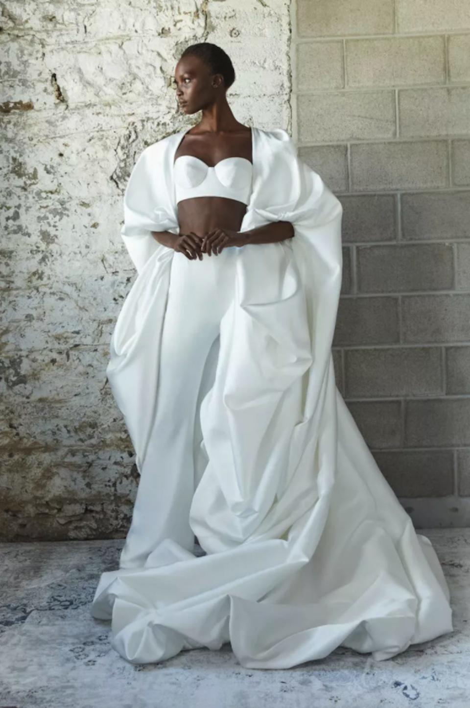 A woman poses in a bridal top and pants.