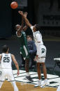 Michigan State's Marcus Bingham Jr., right, blocks a shot by Eastern Michigan's Miles Gibson during the second half of an NCAA college basketball game Wednesday, Nov. 25, 2020, in East Lansing, Mich. Michigan State won 83-67. (AP Photo/Al Goldis)