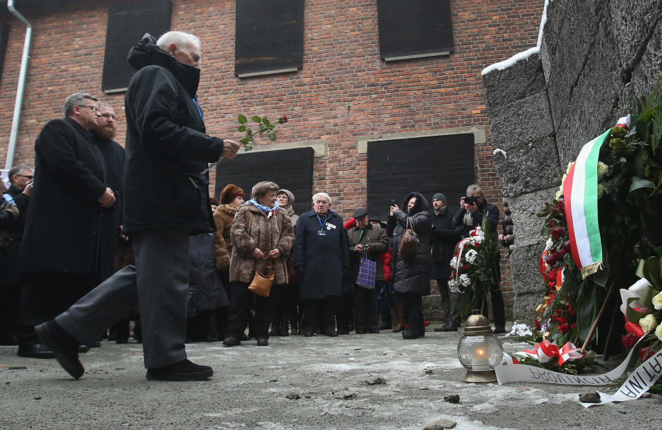 Polish President Bronislaw Komorowski (L) looks on as members of an association of Auschwitz concentration camp survivors arrive to lay wreaths and flowers at the execution wall at the former Auschwitz I concentration camp on January 27, 2015 in Oswiecim, Poland. International heads of state, dignitaries and over 300 Auschwitz survivors are attending the commemorations for the 70th anniversary of the liberation of Auschwitz by Soviet troops on 27th January, 1945. Auschwitz was among the most notorious of the concentration camps run by the Nazis during WWII and whilst it is impossible to put an exact figure on the death toll it is alleged that over a million people lost their lives in the camp, the majority of whom were Jewish.