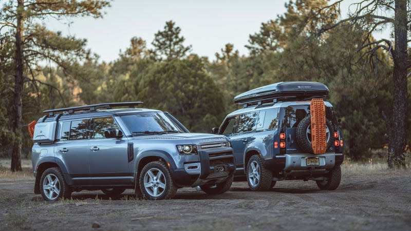 A photo of two Land Rover Defender SUVs. 