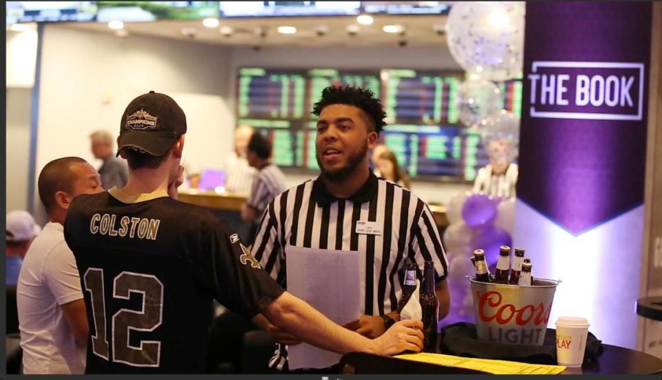 A sports book writer talks to customers at the sports book at Harrah’s Gulf Coast in Biloxi in this file photo. A bill to allow online sports betting has died in committee.