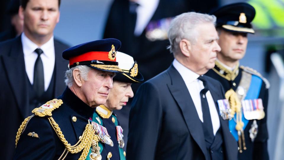 Prince Andrew standing in front of his siblings Princess Anne and King Charles