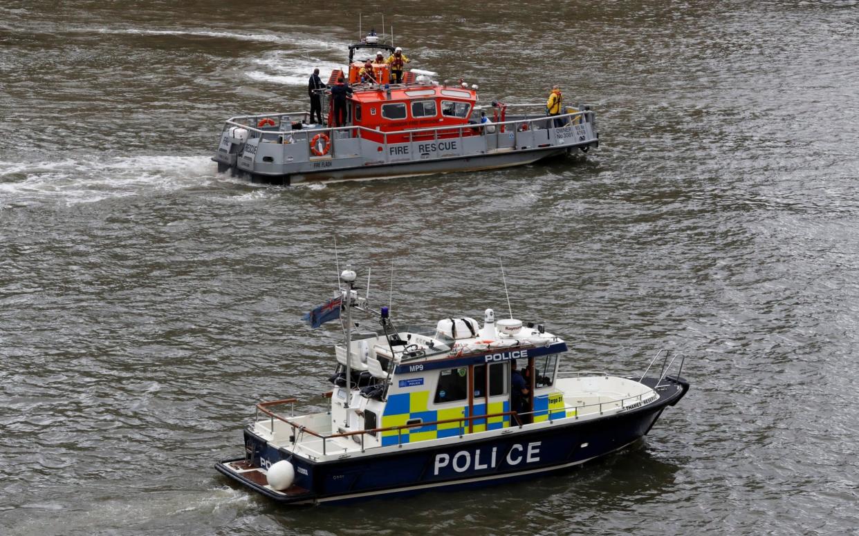 Rescue boats search for the man after he fell from Westminster Bridge - REUTERS