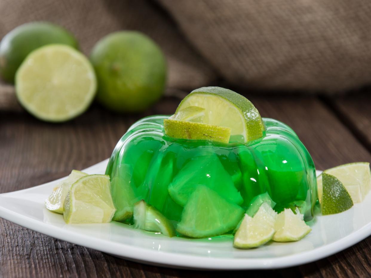 Lime Jello with fresh fruits in the background