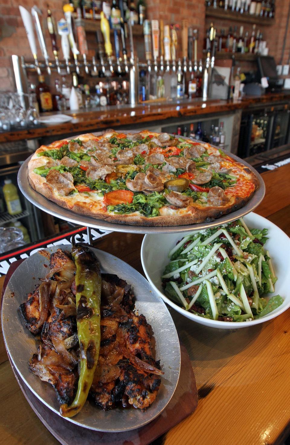 Giuseppe pizza, apple salad romaine and oven-roasted wings at the Tommy's Tavern + Tap in Sea Bright, New Jersey. The first Tommy's Tavern + Tap in Delaware is scheduled to open in November at the Christiana Mall.