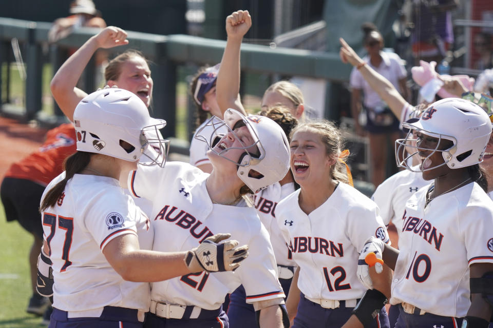 Auburn catcher Aubrie Lisenby (21), Carlee McCondichie (12) and Makayla Packer (10), celebrate with Bri Ellis (77) after her home run during an NCAA softball game on Friday, May 20, 2022, in Clemson, S.C. Auburn won 4-3. (AP Photo/Sean Rayford)