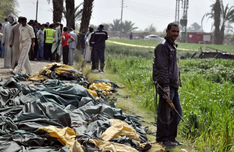 Egyptians gather at the site where a hot air balloon exploded over the ancient temple city of Luxor on February 26, 2013. The accident killed up to 19 tourists, including Asians and Europeans, sources said. The balloon carrying 21 people was flying at 300 metres (1,000 feet) when it caught fire, a security official said