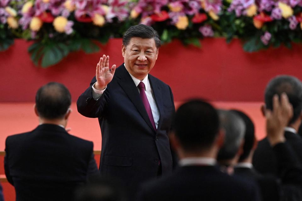 TOPSHOT - China's President Xi Jinping waves following his speech after a ceremony to inaugurate the city's new leader and government in Hong Kong on July 1, 2022, on the 25th anniversary of the city's handover from Britain to China. (Photo by Selim CHTAYTI / POOL / AFP) (Photo by SELIM CHTAYTI/POOL/AFP via Getty Images) ORIG FILE ID: AFP_32DL269.jpg