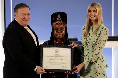 U.S. Secretary of State Mike Pompeo and White House senior advisor Ivanka Trump award Francisca Awah Mbuli, survivor of human trafficking from Cameroon, during an event to unveil the 2018 Trafficking in Persons (TIP) Report at the State Department in Washington, U.S., June 28, 2018. REUTERS/Yuri Gripas