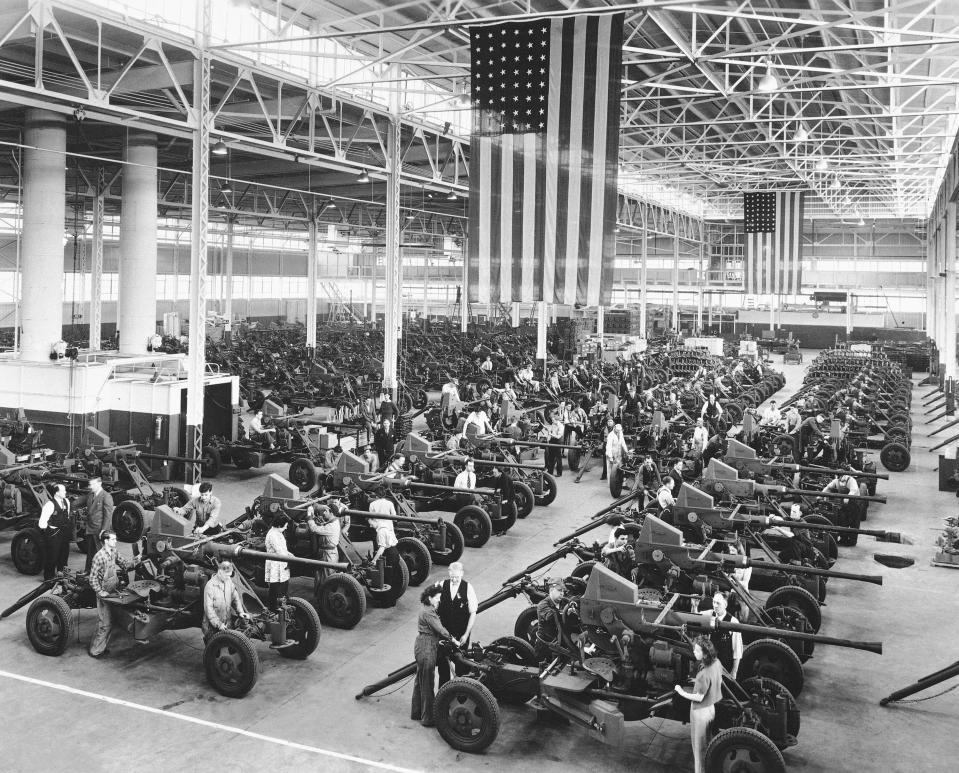 FILE - In this April 3, 1944, file photo Bofors guns used by the Army and Navy are shown lined up at the Firestone Tire & Rubber Co. in Akron, Ohio. Not since World War II when factories converted from making automobiles to making tanks, Jeeps and torpedos has the entire nation been asked to truly sacrifice for a greater good. (AP Photo, File)