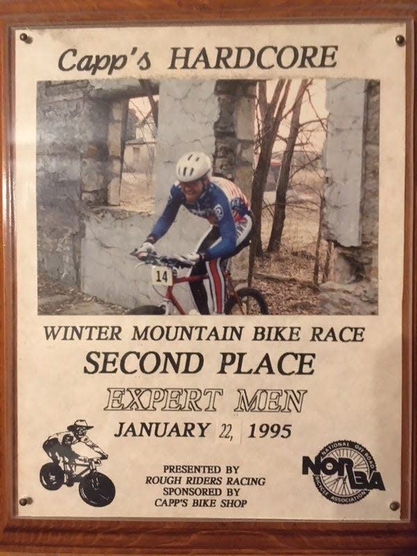 The second-place plaque belonging to Kris Tilford shows a photo of him riding through the old Dornwood Dairy Barn at Dornwood Nature Trails in 1995 during a race put on by then trail coordinator Gilbert Amis. Tilford said he usually placed second because his brother, Steve Tilford, won most local races at the time.