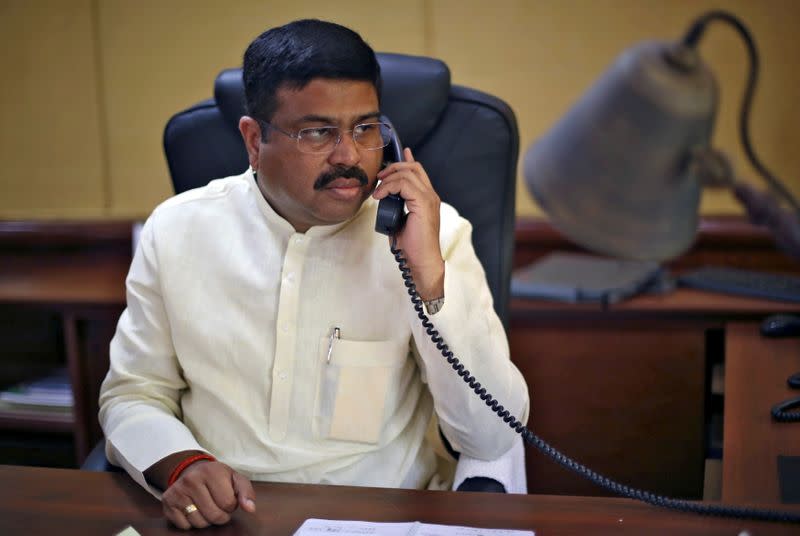 FILE PHOTO: India's Oil Minister Pradhan speaks on phone during an interview with Reuters in New Delhi