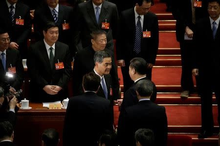 China's President Xi Jinping shakes hands with Hong Kong Chief Executive, vice-chairman of the National Committee of Chinese People's Political Consultative Conference (CPPCC), Leung Chun-ying, during the closing session of the CPPCC at the Great Hall of the People in Beijing, China, March 13, 2017. REUTERS/Jason Lee