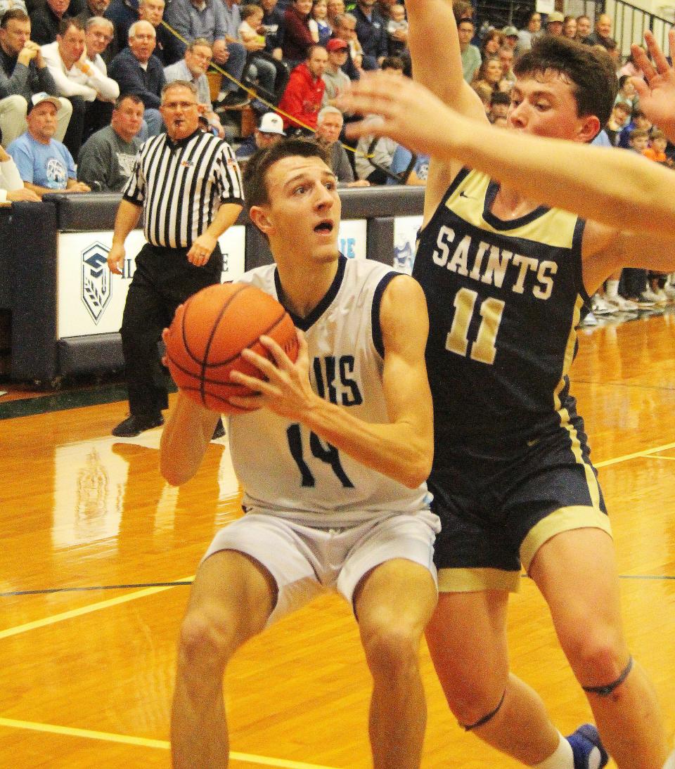 Prairie Central's Dylan Bazzell tries to take a shot against Central Catholic Tuesday. Bazzell scored 34 points to surpass the 1,000-point mark for his career in the 72-66 PC victory.