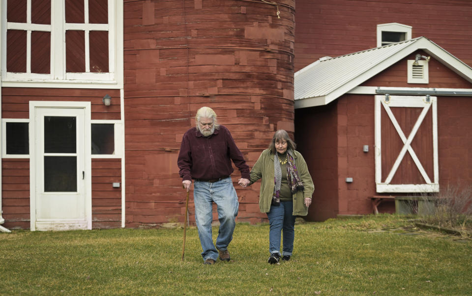 Joan and Harold Koster walk on their property, known as Itaska Valley Farm, Wednesday, March 13, 2024, in Whitney Point, N.Y. The Kosters were asked by Texas-based Southern Tier Energy Solutions to lease their land to extract natural gas by injecting carbon dioxide into the ground, which they rejected and are opposed to. (AP Photo/Heather Ainsworth)