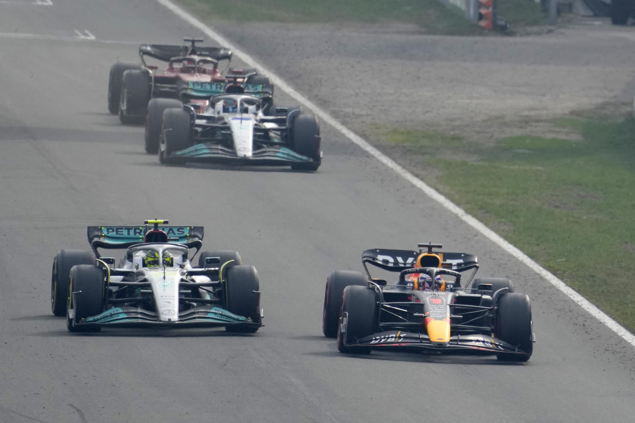 Red Bull driver Max Verstappen of the Netherlands, right, overtakes Mercedes driver Lewis Hamilton of Britain during the Formula 1 Dutch Grand Prix auto race, at the Zandvoort racetrack, in Zandvoort, Netherlands, Sunday, Sept. 4, 2022. (AP Photo/Peter Dejong)