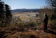 The Wider Image: Japan's tsunami survivors call lost loves on the phone of the wind