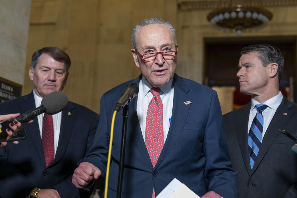 Sen. Mike Rounds, R-S.D., left, Senate Majority Leader Chuck Schumer of N.Y., Sen. Todd Young, R-Ind., speak after a bipartisan Senate forum on artificial intelligence, on Capitol Hill, Wednesday, Nov. 8, 2023, in Washington. (AP Photo/Alex Brandon)