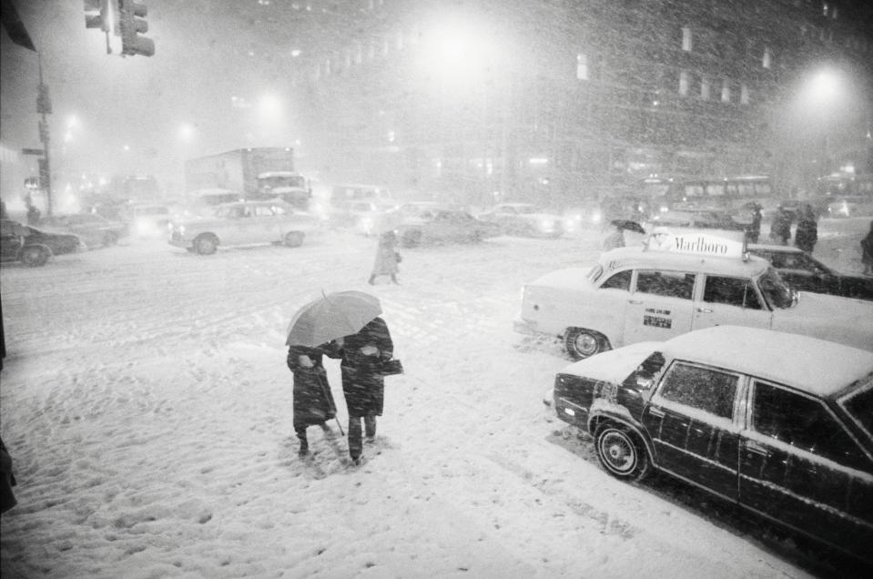 A group of pedestrians cross the traffic-snarled intersection of 42nd St. and Third Ave. February 11, as near-blizzard conditions paralyzed the New York area. Thunder and lightning bolted through Manhattan while city officials declared a snow emergency in effect. February 11, 1983.