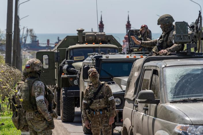 Russian servicemen patrol a street in Berdyansk.