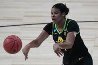 FILE - In this March 24, 2021, file photo, Oregon forward Nyara Sabally passes the ball during the first half of a college basketball game against Georgia in the second round of the women's NCAA tournament at the Alamodome in San Antonio. Coach Kelly Graves has guided Oregon to four straight Sweet Sixteen appearances. Now, Nyara Sabally — Oregon's leading returner — can't wait to play in front of home fans for the first time. "They've never seen any of our team play live yet," she said. (AP Photo/Eric Gay, File)